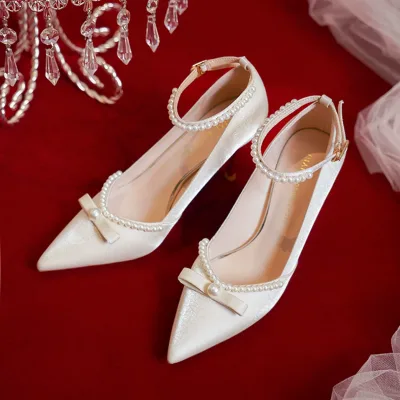 Wedding shoe photo with pointed stiletto heel, pearl embellishments, and trendy style