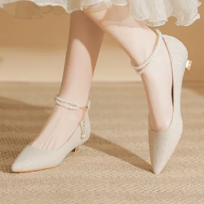 Photo of a bride's shoe with a short heel and pointed toe, trendy this year
