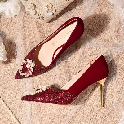 Photo of a shiny, genuine maroon pointed bridal shoe