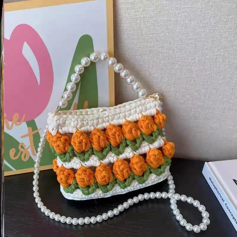 Photo of a handmade knitted bag with shoulder straps, featuring original girl-themed patterns Photo of a handmade knitted bag with shoulder straps made of marari material, in a girlie orange color, original.